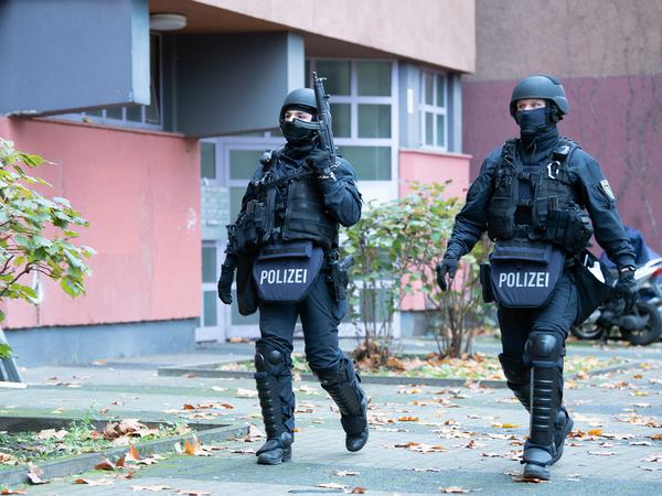 Polizeibeamte gehen zu einem Wohnhaus an der Gitschiner Straße. 