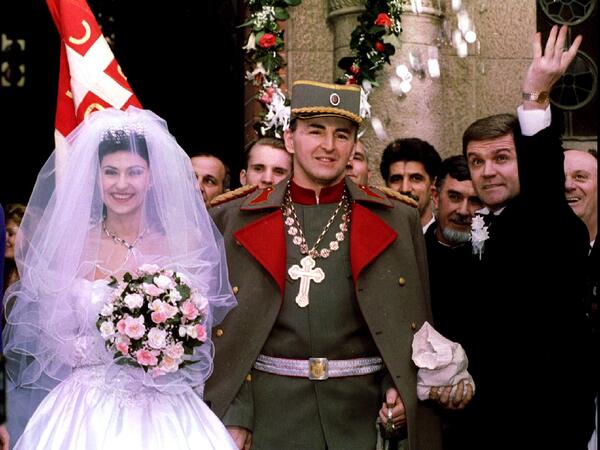 Serb paramilitary leader Zeljko Raznatovic "Commander Arkan" and his new bride popular Serbian folk singer Ceca Velickovic pose while his best man throws coins for luck after their wedding at Serbian Orthodox church in Belgrade February 19. Raznatovic's private army waged bloody war in the break-up of Yugoslavia
ArkanCeca26